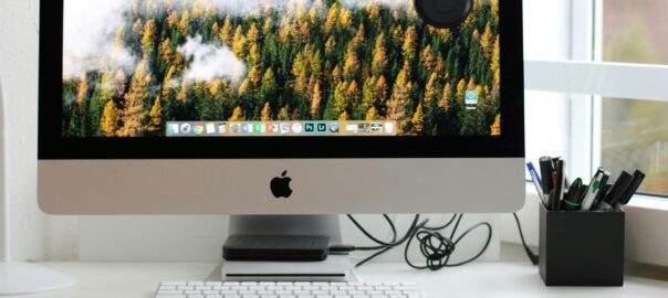 Free Stylish home office workspace featuring a computer setup with accessories. Stock Photo